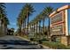 A neighborhood sign surrounded by palm trees, a parking garage, and luxury apartments at 2201 Ramsgate Dr # 327, Henderson, NV 89074