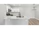 This kitchen offers stone countertops, white cabinets, and a black gooseneck faucet at 2201 Ramsgate Dr # 327, Henderson, NV 89074