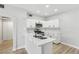Bright kitchen features white cabinets, stone countertops, a gas range, and a black gooseneck faucet at 2201 Ramsgate Dr # 327, Henderson, NV 89074