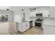 Well-lit kitchen features bright white cabinets, stainless steel appliances, and an island sink at 2201 Ramsgate Dr # 327, Henderson, NV 89074