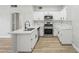 Updated kitchen with stainless steel appliances, white cabinets, and sleek countertops at 2201 Ramsgate Dr # 327, Henderson, NV 89074