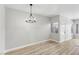 Open floor plan with dining area, light floors, and a modern chandelier, and lots of light at 2201 Ramsgate Dr # 327, Henderson, NV 89074