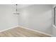 Empty room with wood floors, chandelier, and natural light streaming through a window at 2201 Ramsgate Dr # 327, Henderson, NV 89074