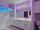 Bathroom featuring double sinks, a large mirror, and a glass-enclosed shower at 2343 Scotch Lake St, Las Vegas, NV 89134