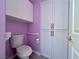 Cozy bathroom featuring white cabinets, toilet and grab bar for accessibility at 2343 Scotch Lake St, Las Vegas, NV 89134