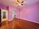 Hardwood floored bedroom with lilac-painted walls and mirrored closet doors at 2343 Scotch Lake St, Las Vegas, NV 89134
