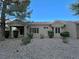 Charming single story home with a cozy front porch, desert landscaping, and a red tile roof at 2343 Scotch Lake St, Las Vegas, NV 89134