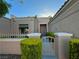 Close-up of a single-story home's front entrance featuring a gate and rock landscaping at 2343 Scotch Lake St, Las Vegas, NV 89134