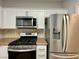 Close-up of stainless steel oven, microwave, and refrigerator in the kitchen at 2343 Scotch Lake St, Las Vegas, NV 89134