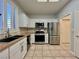 Well-lit kitchen with stainless steel appliances, granite countertops, and tile flooring at 2343 Scotch Lake St, Las Vegas, NV 89134