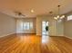 Spacious living room with hardwood floors, fan, shutters, and a glass sliding door at 2343 Scotch Lake St, Las Vegas, NV 89134