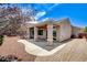 Charming backyard with covered patio, mature landscaping, and paved walkway at 2804 Sapphire Desert Dr, Henderson, NV 89052