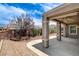 Charming backyard with covered patio, mature landscaping, and paved walkway at 2804 Sapphire Desert Dr, Henderson, NV 89052