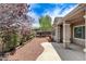 Charming backyard with covered patio, mature landscaping, and paved walkway at 2804 Sapphire Desert Dr, Henderson, NV 89052