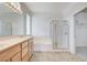 Bright bathroom features a double sink vanity, soaking tub, and glass-enclosed shower at 2804 Sapphire Desert Dr, Henderson, NV 89052