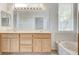 Bathroom features a double sink vanity, a soaking tub, and a large well-lit mirror at 2804 Sapphire Desert Dr, Henderson, NV 89052