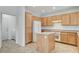 Bright kitchen with oak cabinets, center island, and tile floors at 2804 Sapphire Desert Dr, Henderson, NV 89052