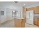 Bright kitchen featuring tile floors, oak cabinets, and center island at 2804 Sapphire Desert Dr, Henderson, NV 89052