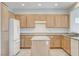 Kitchen featuring light wood cabinets, a center island, and modern appliances at 2804 Sapphire Desert Dr, Henderson, NV 89052