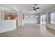 Spacious living room with neutral tile, ceiling fan, and sliding glass doors to the backyard at 2804 Sapphire Desert Dr, Henderson, NV 89052