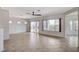 Bright living room with large windows, tile flooring, and sliding glass doors to the backyard at 2804 Sapphire Desert Dr, Henderson, NV 89052