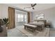 Spacious main bedroom with neutral tones, a ceiling fan, and a large bay window at 2804 Sapphire Desert Dr, Henderson, NV 89052