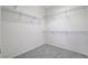 Spacious walk-in closet features white walls, gray carpeting, and metal storage shelves at 2804 Sapphire Desert Dr, Henderson, NV 89052