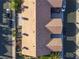 Detailed aerial view of the homes featuring clay tile roofs and well-maintained landscaping at 305 Crosswind Way, Las Vegas, NV 89145