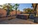 Enclosed backyard featuring a hot tub, patio and block wall at 305 Crosswind Way, Las Vegas, NV 89145