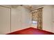 Bedroom featuring a closet with sliding doors and a window with blinds and curtains at 305 Crosswind Way, Las Vegas, NV 89145