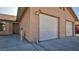 Exterior view of the property featuring a two-car garage and front entrance at 305 Crosswind Way, Las Vegas, NV 89145