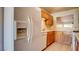 Traditional kitchen featuring wood cabinetry and a refrigerator with water dispenser at 305 Crosswind Way, Las Vegas, NV 89145