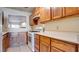 Functional kitchen design with wood cabinets, white countertops, and standard appliances at 305 Crosswind Way, Las Vegas, NV 89145