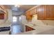 Well-lit kitchen with a combination of wooden cabinets and standard white appliances at 305 Crosswind Way, Las Vegas, NV 89145
