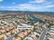 Aerial view of a scenic neighborhood with a lake and lush landscaping at 3109 Siena Cir, Las Vegas, NV 89128