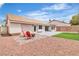 The backyard features synthetic grass, desert landscaping, a lounging area, and privacy walls at 3109 Siena Cir, Las Vegas, NV 89128