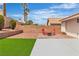 Backyard features a gravel area and a paved patio area with outdoor seating and a patch of artificial turf at 3109 Siena Cir, Las Vegas, NV 89128