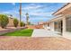 Spacious backyard with an artificial lawn, desert landscaping, and patio space at 3109 Siena Cir, Las Vegas, NV 89128