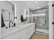 Modern bathroom featuring double sinks, sleek fixtures, and a glass-enclosed shower at 3109 Siena Cir, Las Vegas, NV 89128