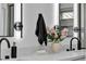 Bathroom featuring double sink vanity, modern mirrors, and black fixtures at 3109 Siena Cir, Las Vegas, NV 89128