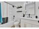 Modern bathroom features a tub and shower combination with floating shelves and stylish fixtures at 3109 Siena Cir, Las Vegas, NV 89128