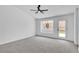 Bright, carpeted bedroom with lots of natural light and a door to the backyard at 3109 Siena Cir, Las Vegas, NV 89128