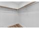 This closet has neutral walls, laminate flooring, baseboards, and a closet rod at 3109 Siena Cir, Las Vegas, NV 89128