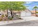 Charming single-story home featuring a three-car garage, desert landscaping, and a well-maintained front yard at 3109 Siena Cir, Las Vegas, NV 89128
