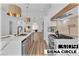 Modern kitchen featuring a quartz island, stainless steel appliances, and stylish pendant lighting at 3109 Siena Cir, Las Vegas, NV 89128