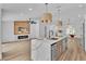 Bright, open kitchen with a large island featuring a breakfast bar and a cozy fireplace in the adjacent living area at 3109 Siena Cir, Las Vegas, NV 89128