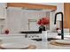 Close-up of a modern kitchen with a marble countertop, decor, and stainless steel range with pot filler at 3109 Siena Cir, Las Vegas, NV 89128