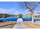 Scenic view of a serene lake with a walking path and mountain backdrop at 3109 Siena Cir, Las Vegas, NV 89128