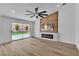 Bright living room boasts a modern fireplace, sleek ceiling fan, and sliding glass doors to the backyard at 3109 Siena Cir, Las Vegas, NV 89128