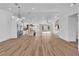 Spacious open-concept living area featuring hardwood floors and recessed lighting, flowing into the kitchen at 3109 Siena Cir, Las Vegas, NV 89128